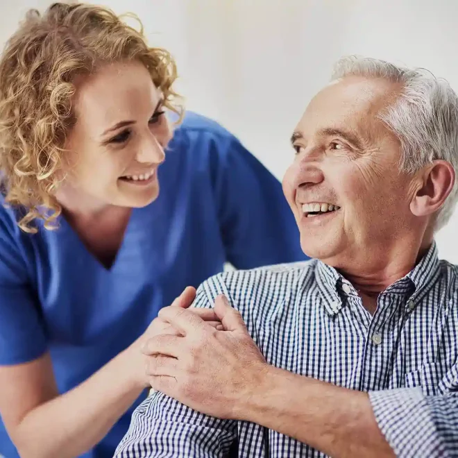 Compassionate caregiver sharing a joyful moment with senior resident at Lakeway Copperleaf Homestead assisted living in Lakeway, TX